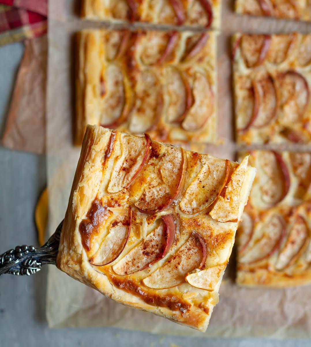 A slice of apple tart on a cake server.