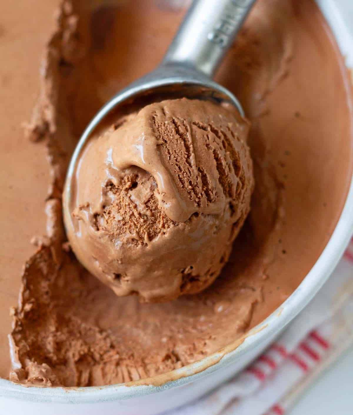 A scoop of chocolate ice cream in an ice cream scoop.