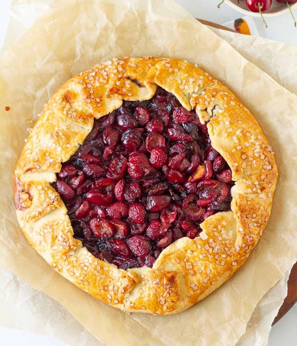 Cherry galette on parchment paper.