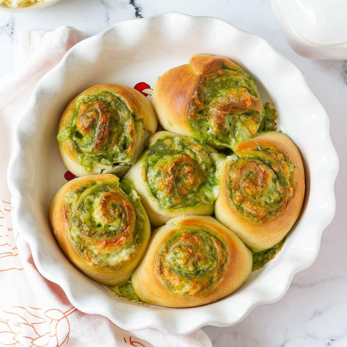pesto rolls in a round baking dish.