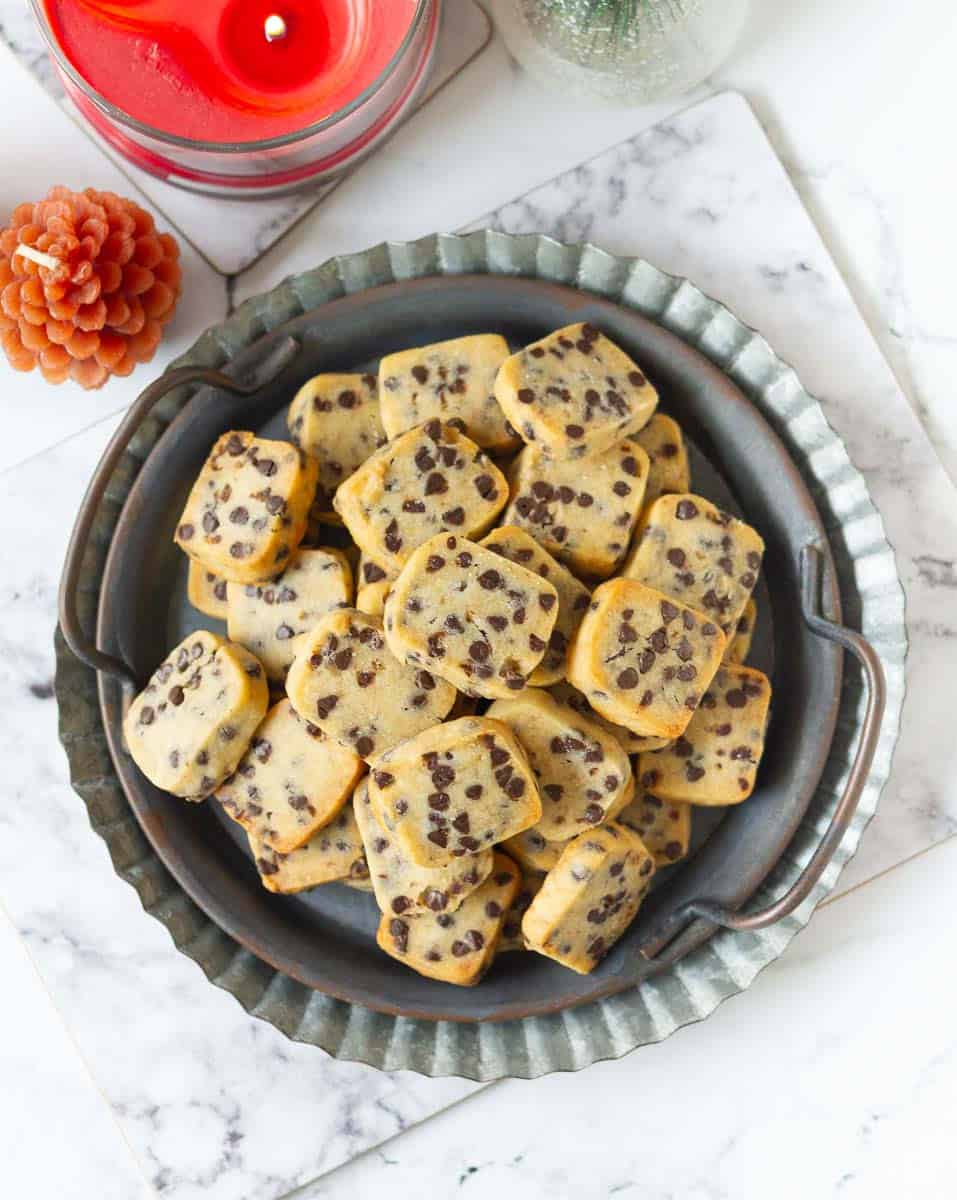 Chocolate chip cookies on a grey metal tray.