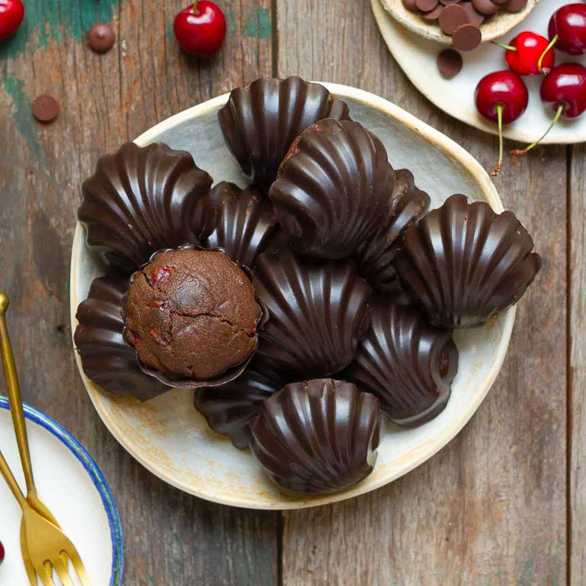 Chocolate cherry madeleines on a plate.