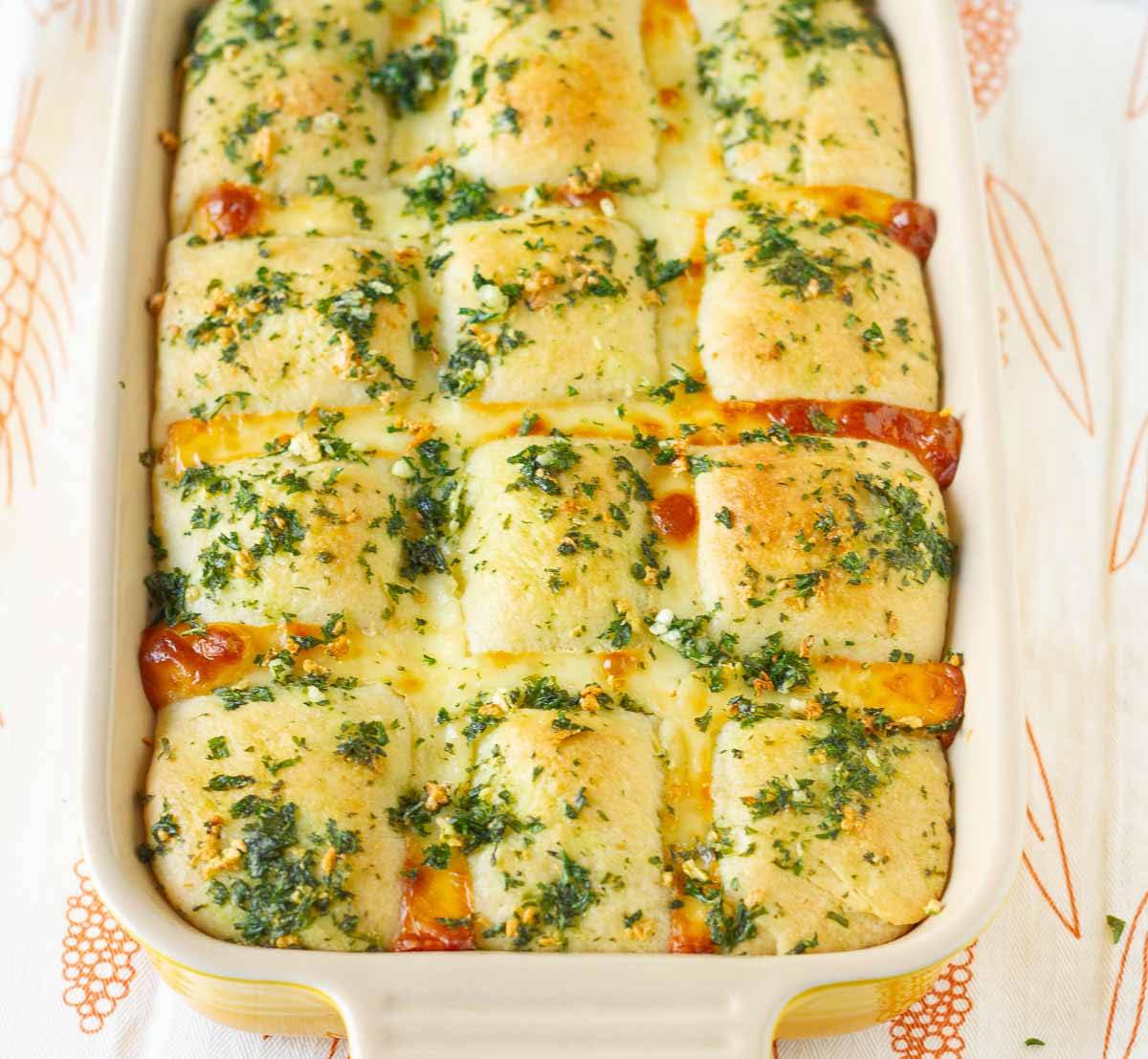 Cheesy garlic bread in a baking pan.