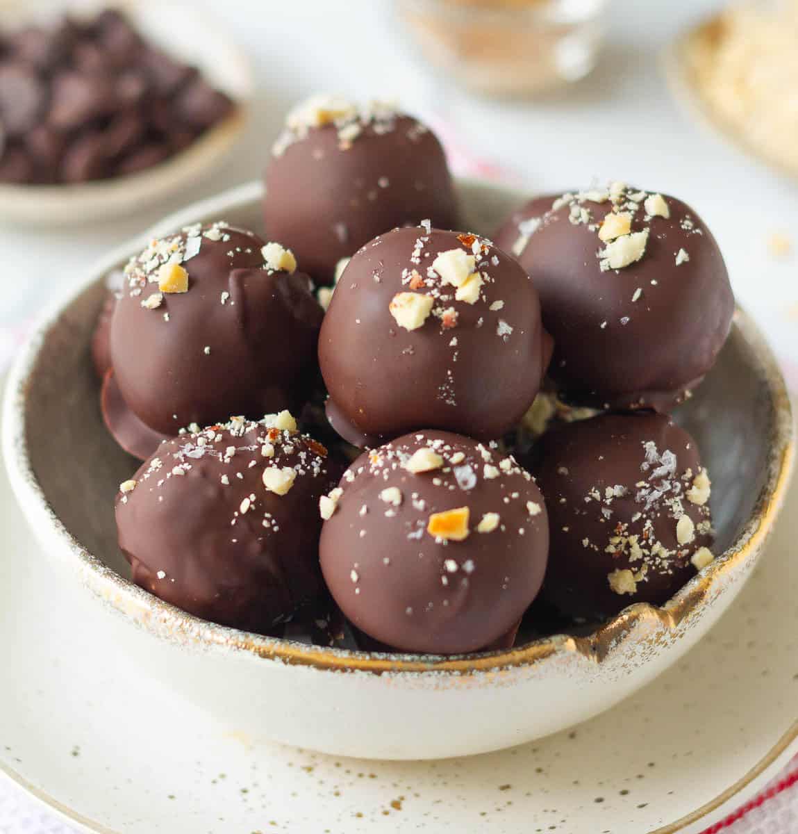 Chocolate covered protein balls in a bowl.