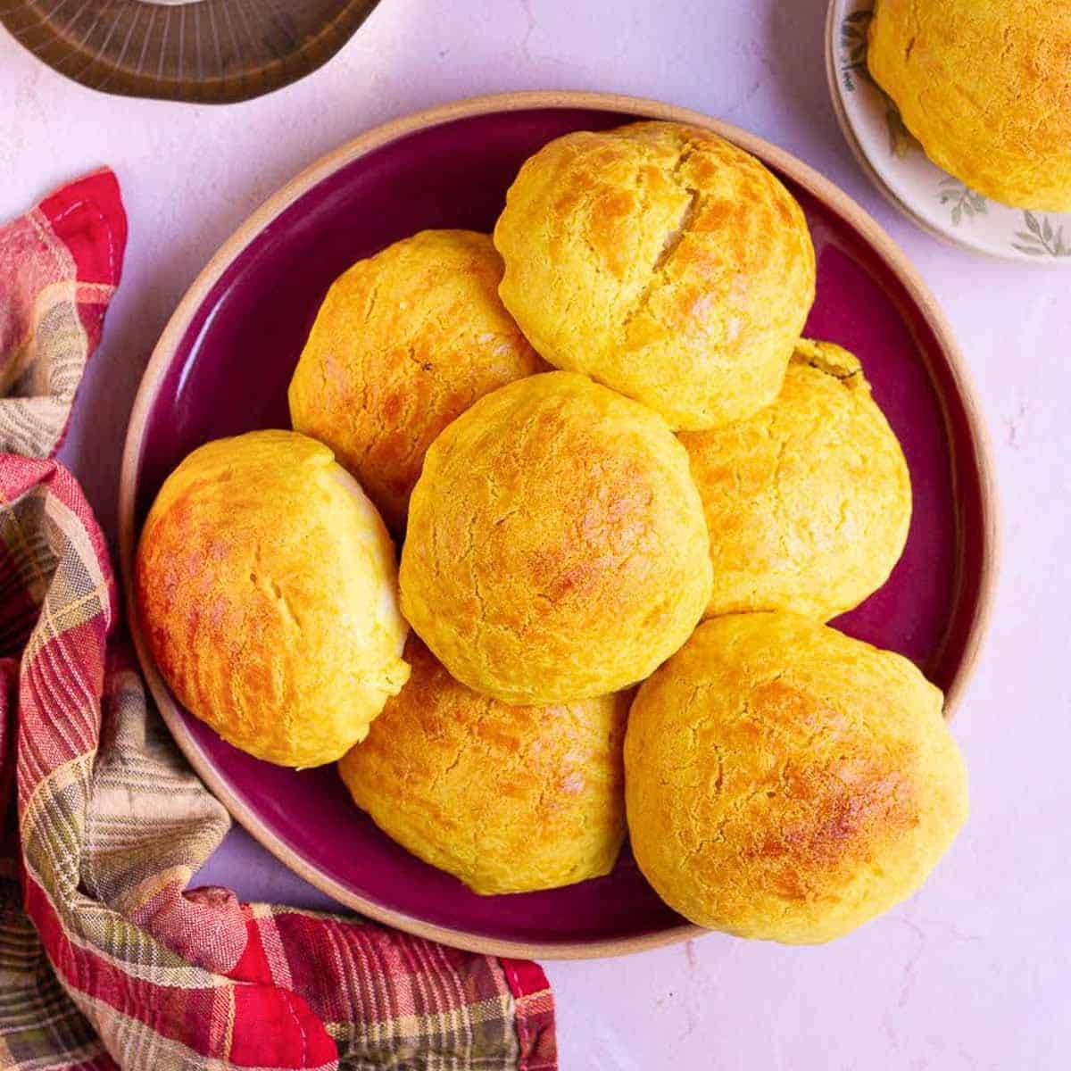 Golden yellow buns on a red platter.