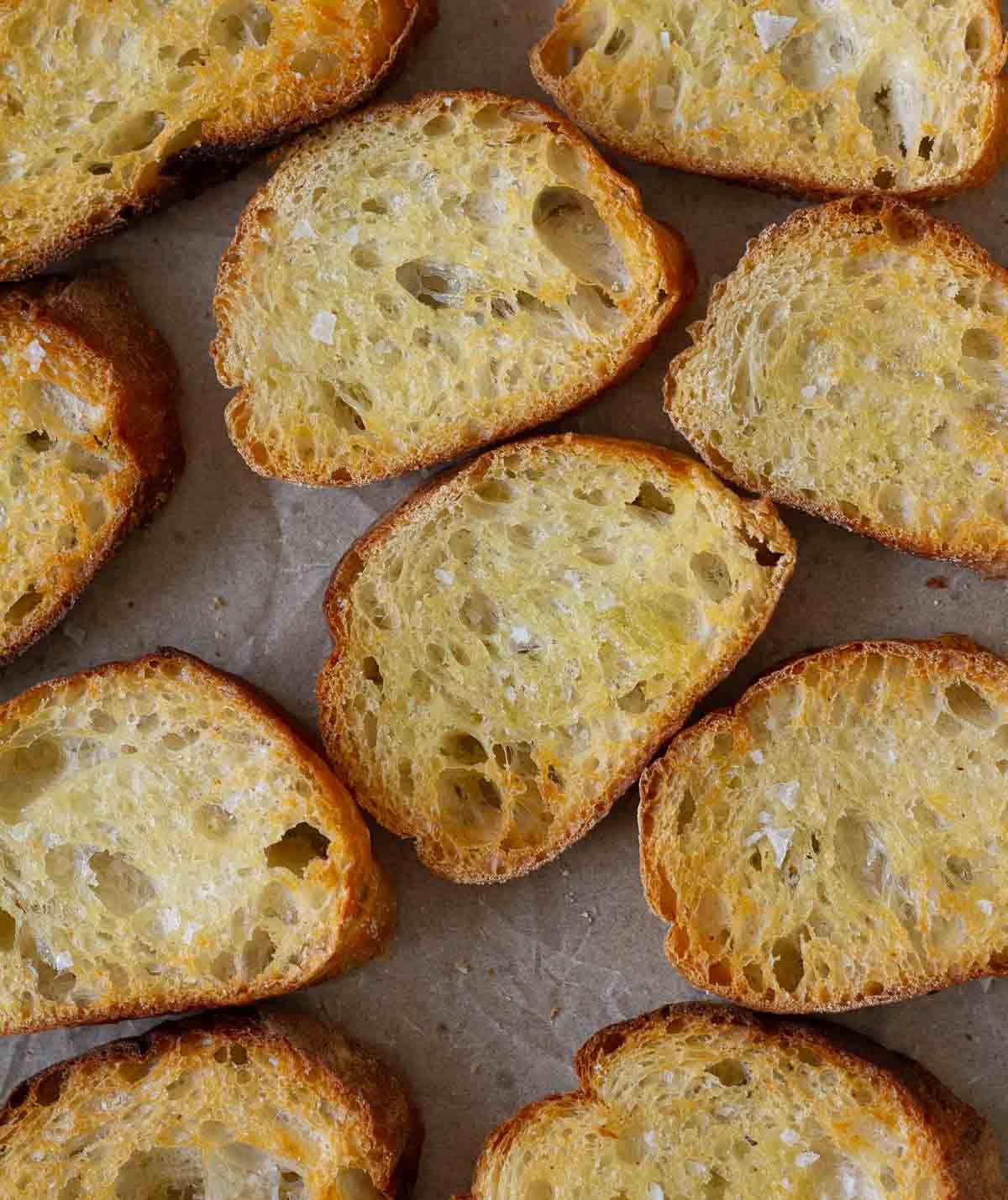 A few crostini on parchment paper.