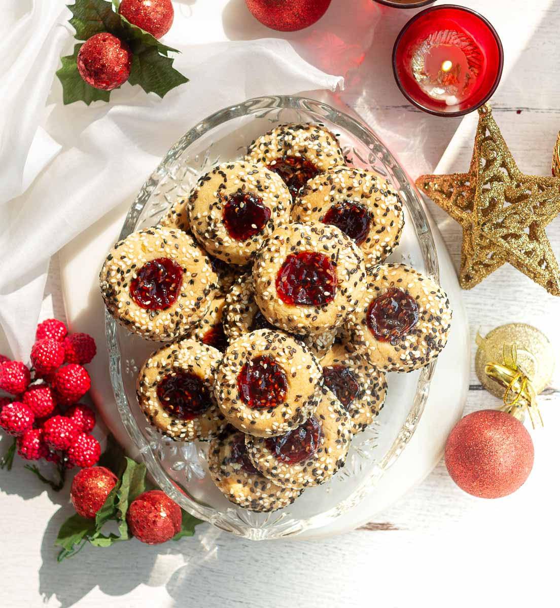 a platter with thumbprint cookies coated with sesame seeds.