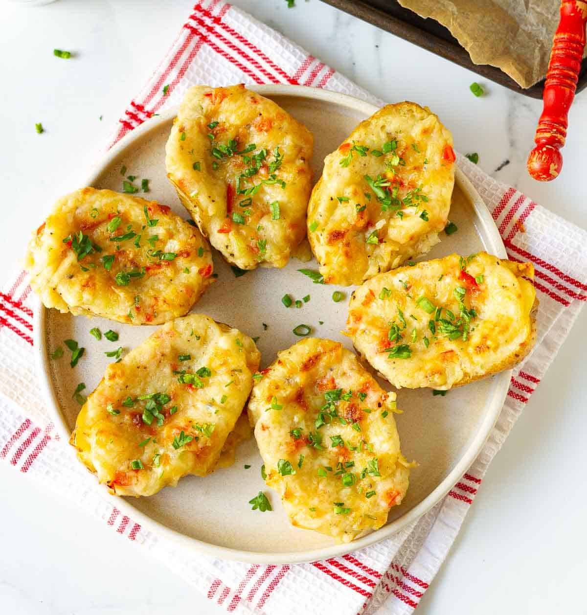 cheesy twice baked potatoes on a plate.