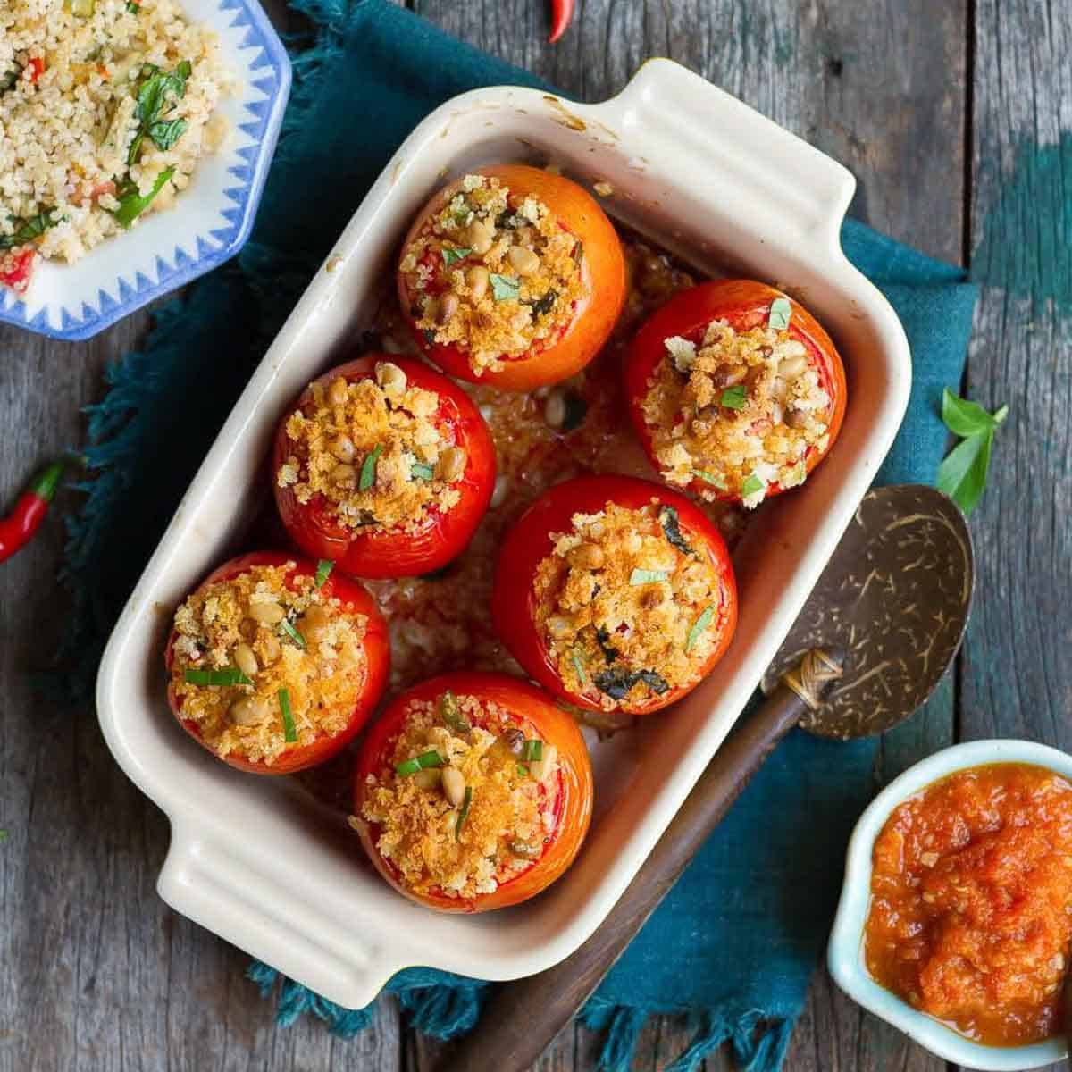 Baked stuffed tomatoes in a casserole dish.