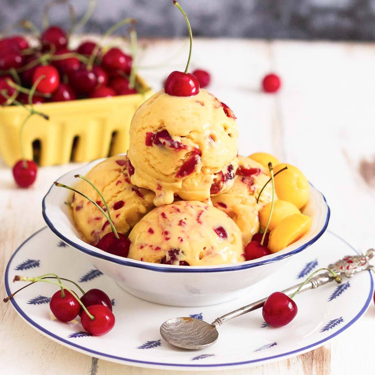 Scoops of mango cherry frozen yogurt in a bowl.