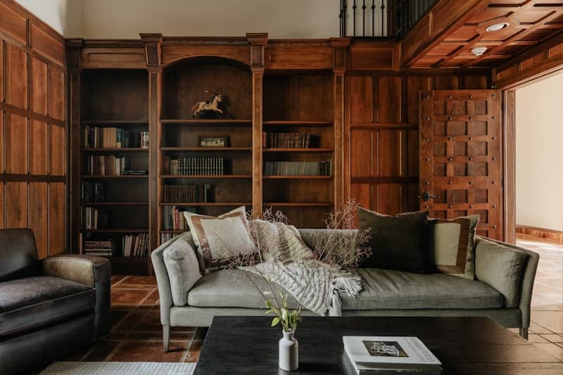 A living room filled with furniture and a book shelf