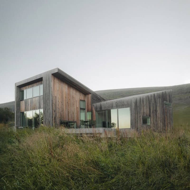 A house sitting on top of a lush green hillside