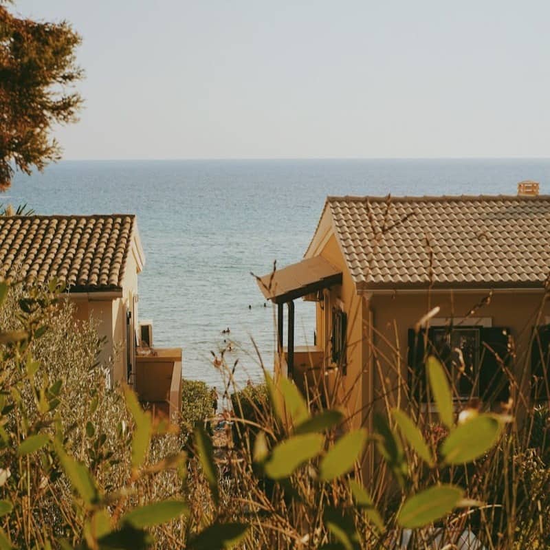 A couple of houses sitting next to a body of water