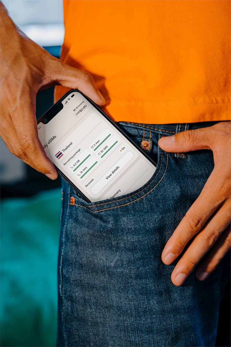 Smartphone being placed in a jeans pocket