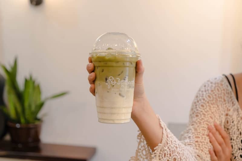 Person is holding an iced matcha latte.