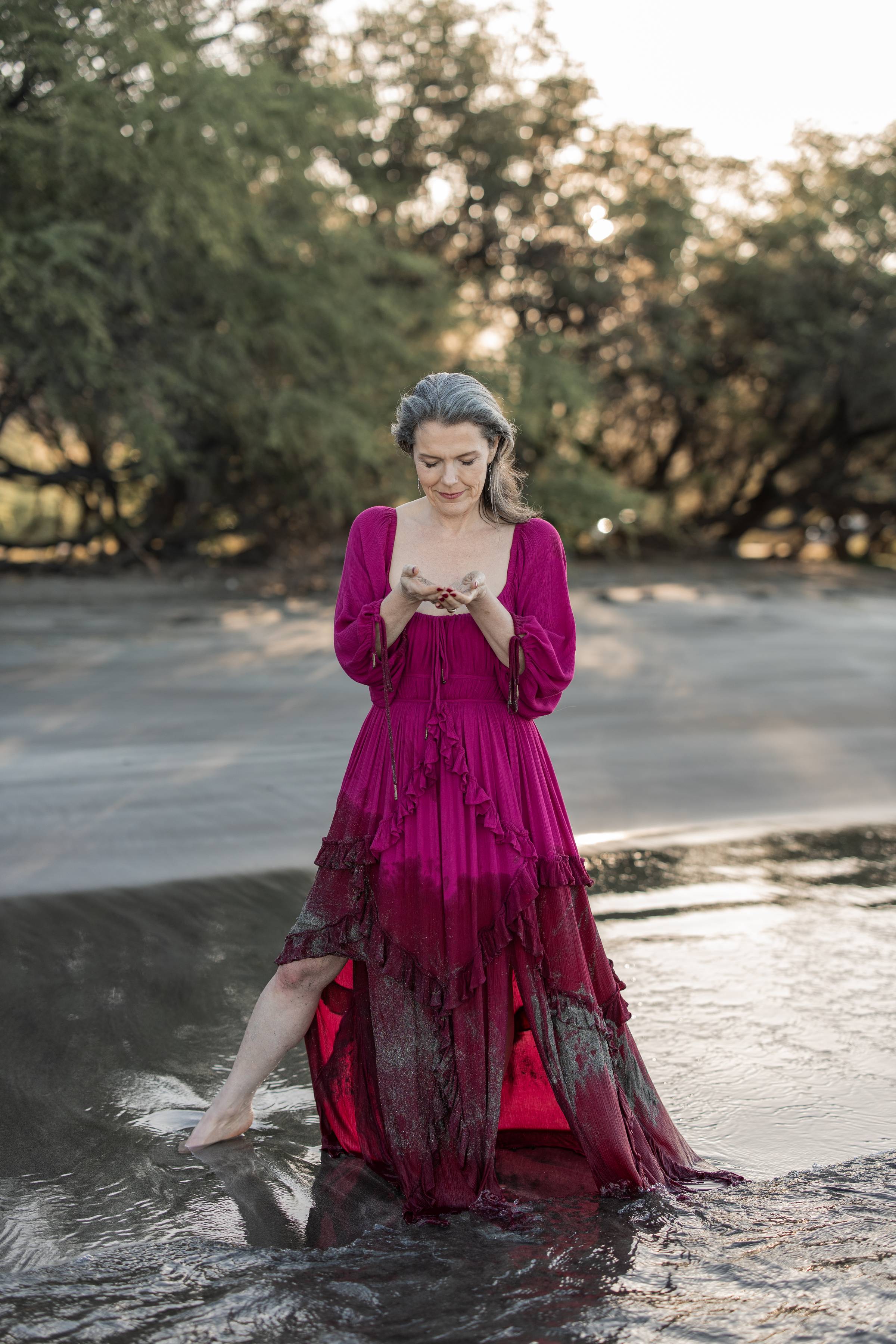 Michele Lisenbury Christensen standing in the shallow water on a beach