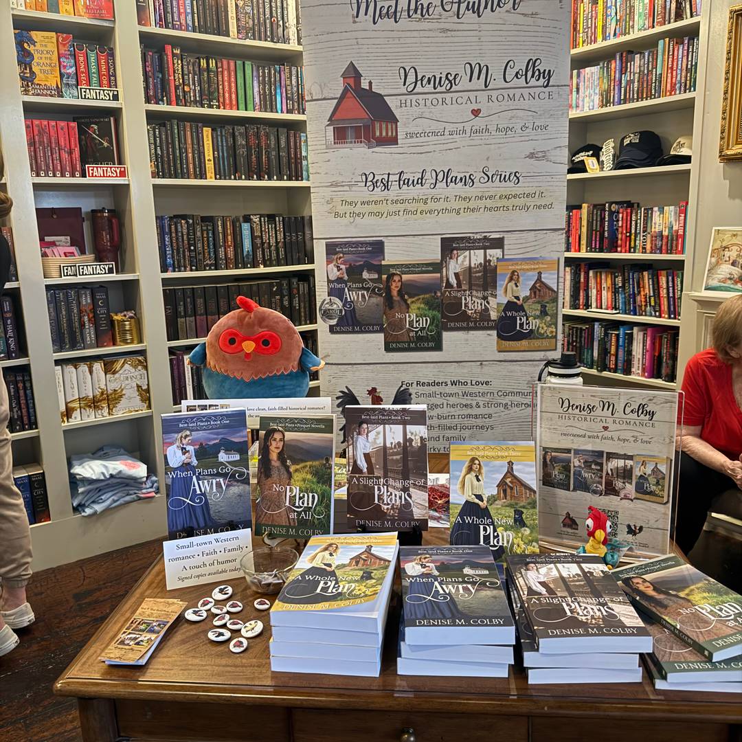 Denise M. Colby's table with her Best-laid Plans Series book signing at In Bloom Bookery June 2026