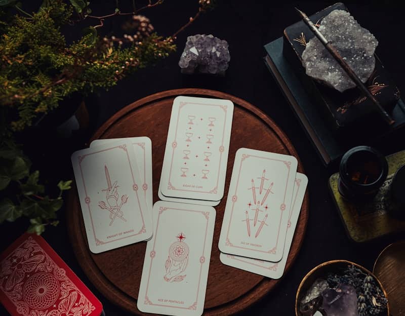 Four playing cards sitting on top of a wooden table