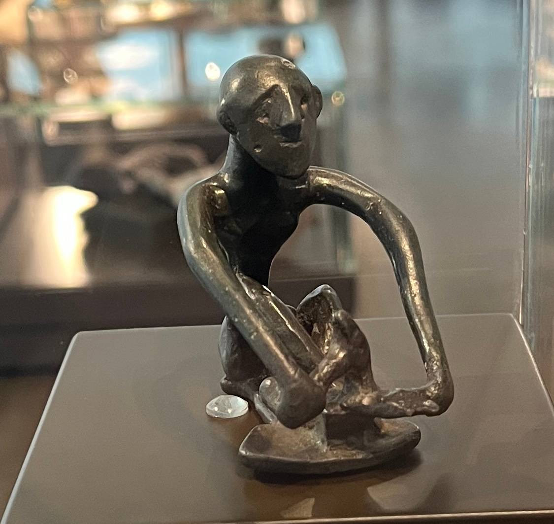 a bronze figure of a sword smith