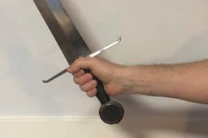 Sword held back in the hand