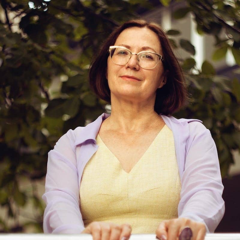 woman in white long sleeve shirt smiling