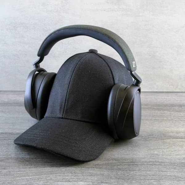 A black baseball cap with headphones on