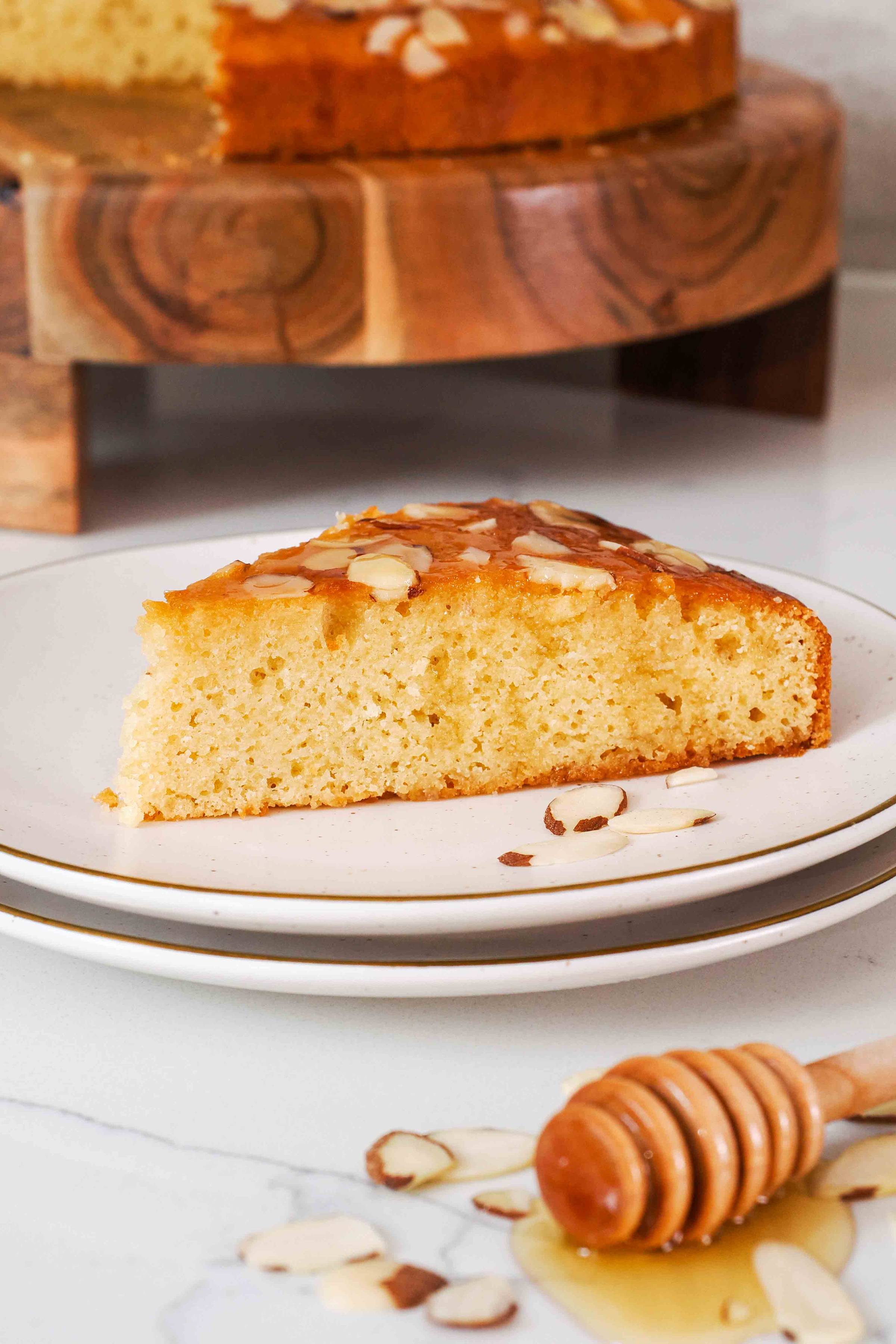 A slice of honey almond cake on a plate