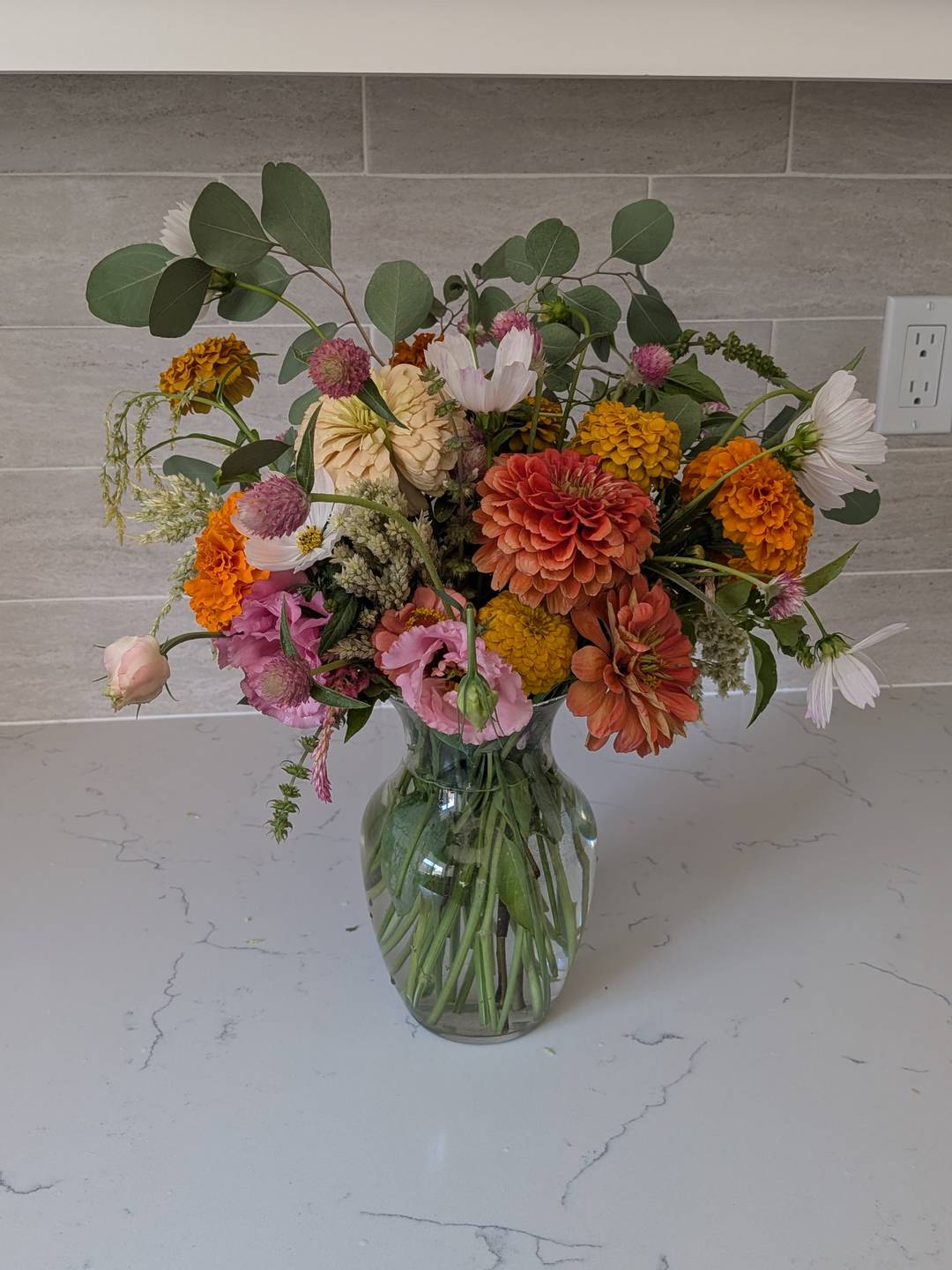 A homegrown flower arrangement in a glass vase.