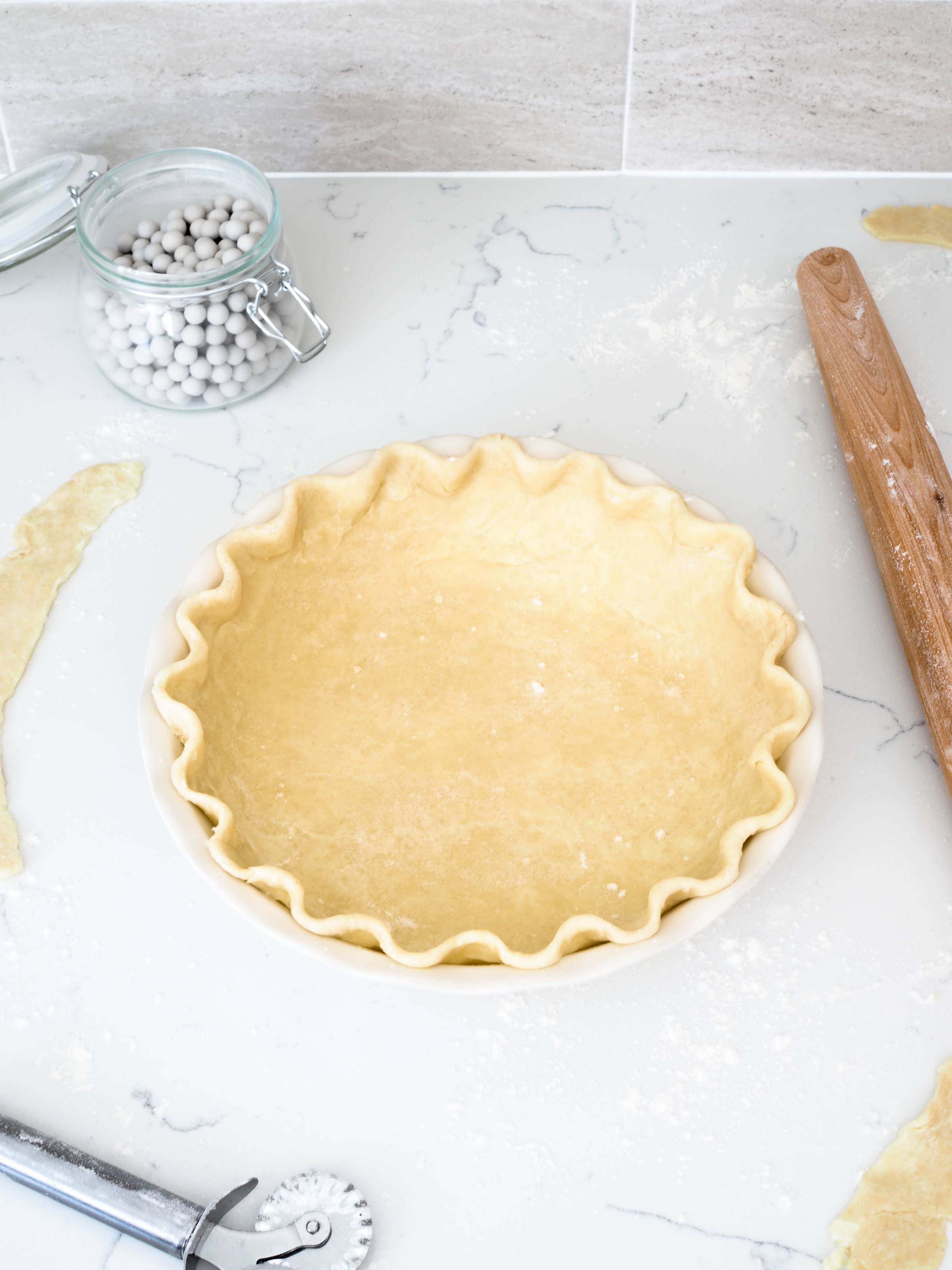 An unbaked pie crust in a pie pan.