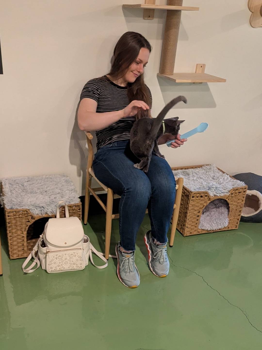 Alyssa with a cat in her lap.