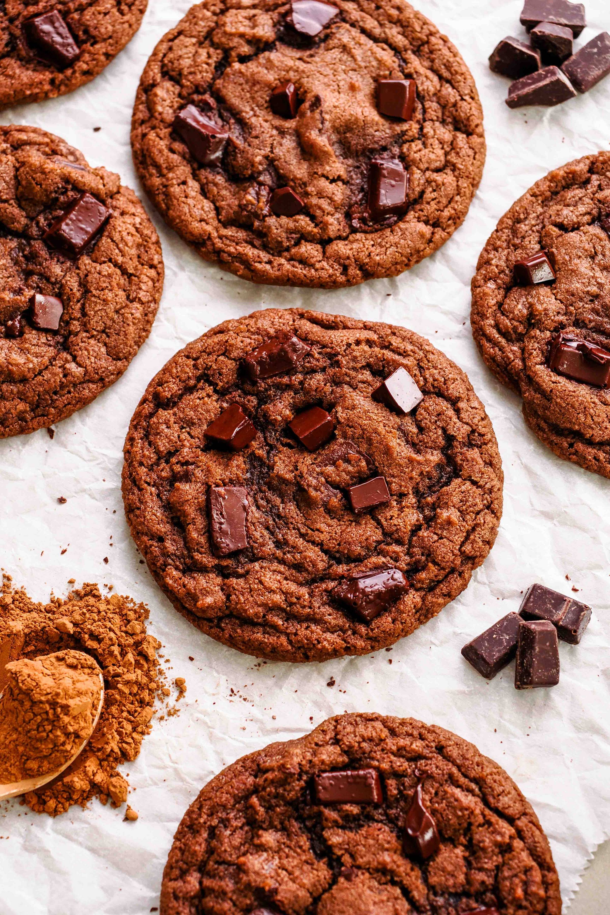 A double chocolate chip cookie on parchment paper.