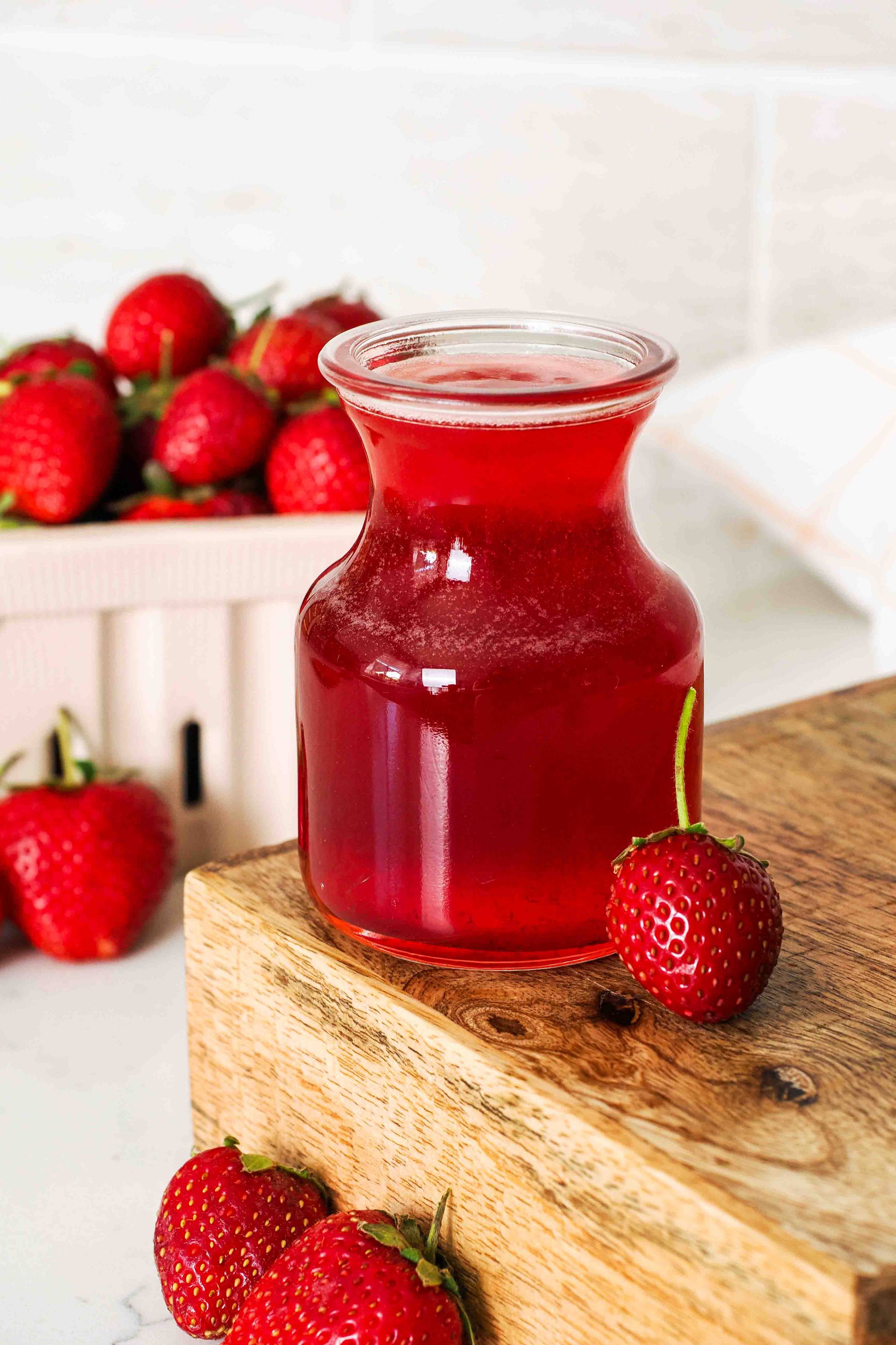 A small bottle of strawberry syrup