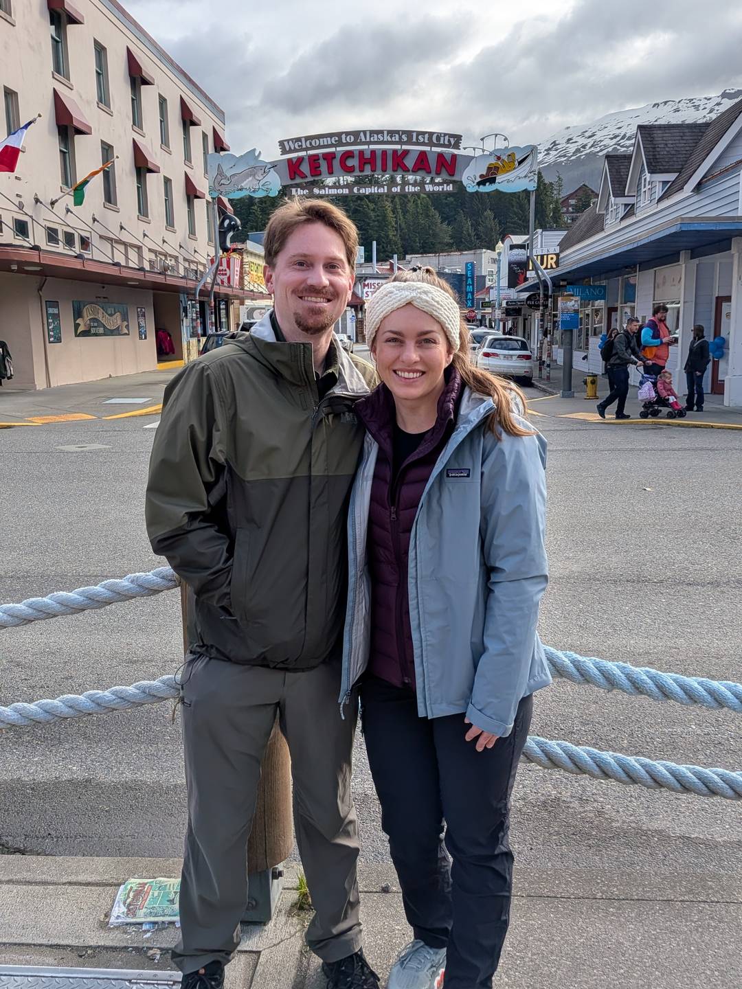 Austin and Alyssa in front of a sign that says "Ketchikan"