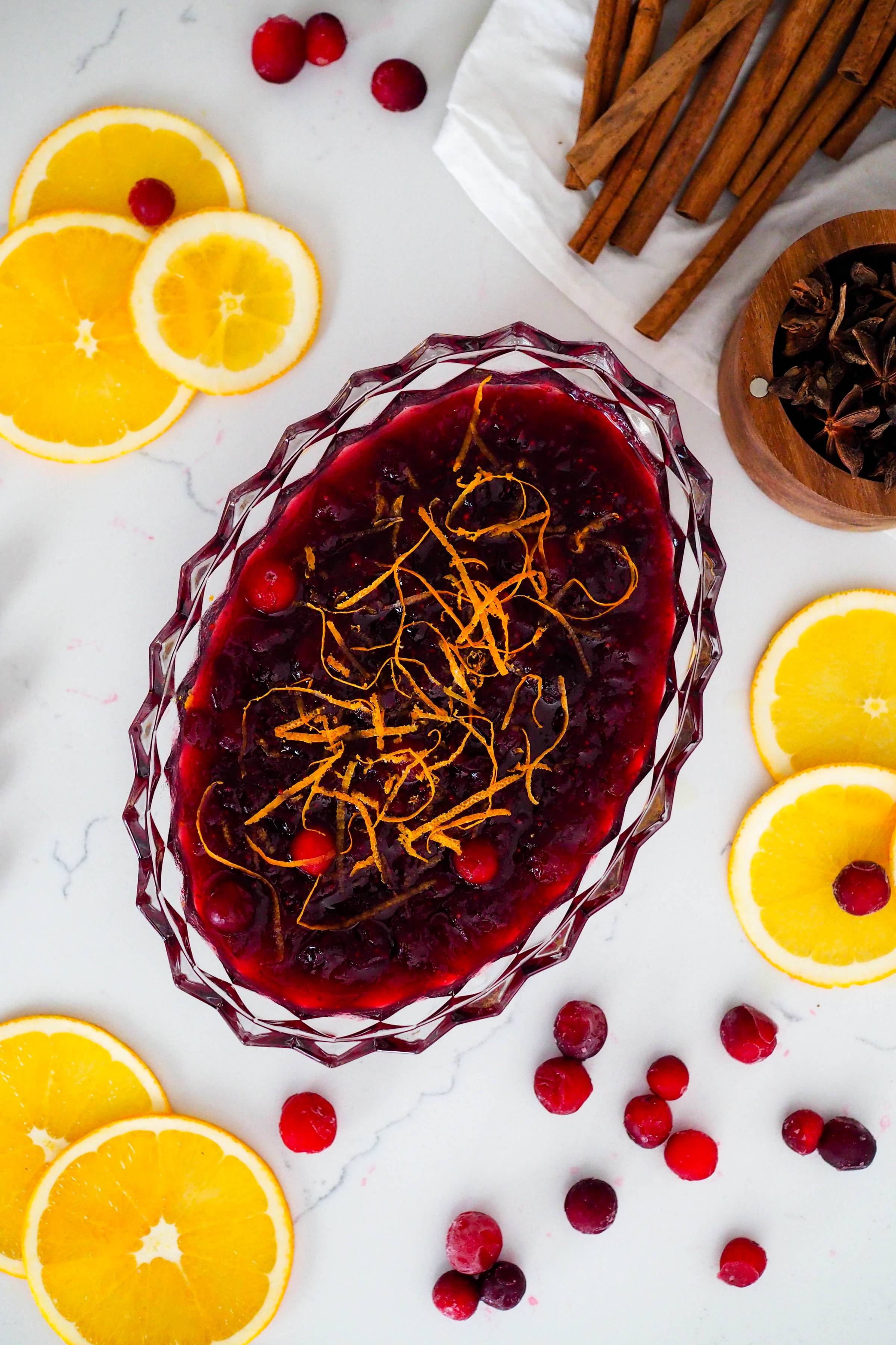 A crystal bowl of cranberry sauce.