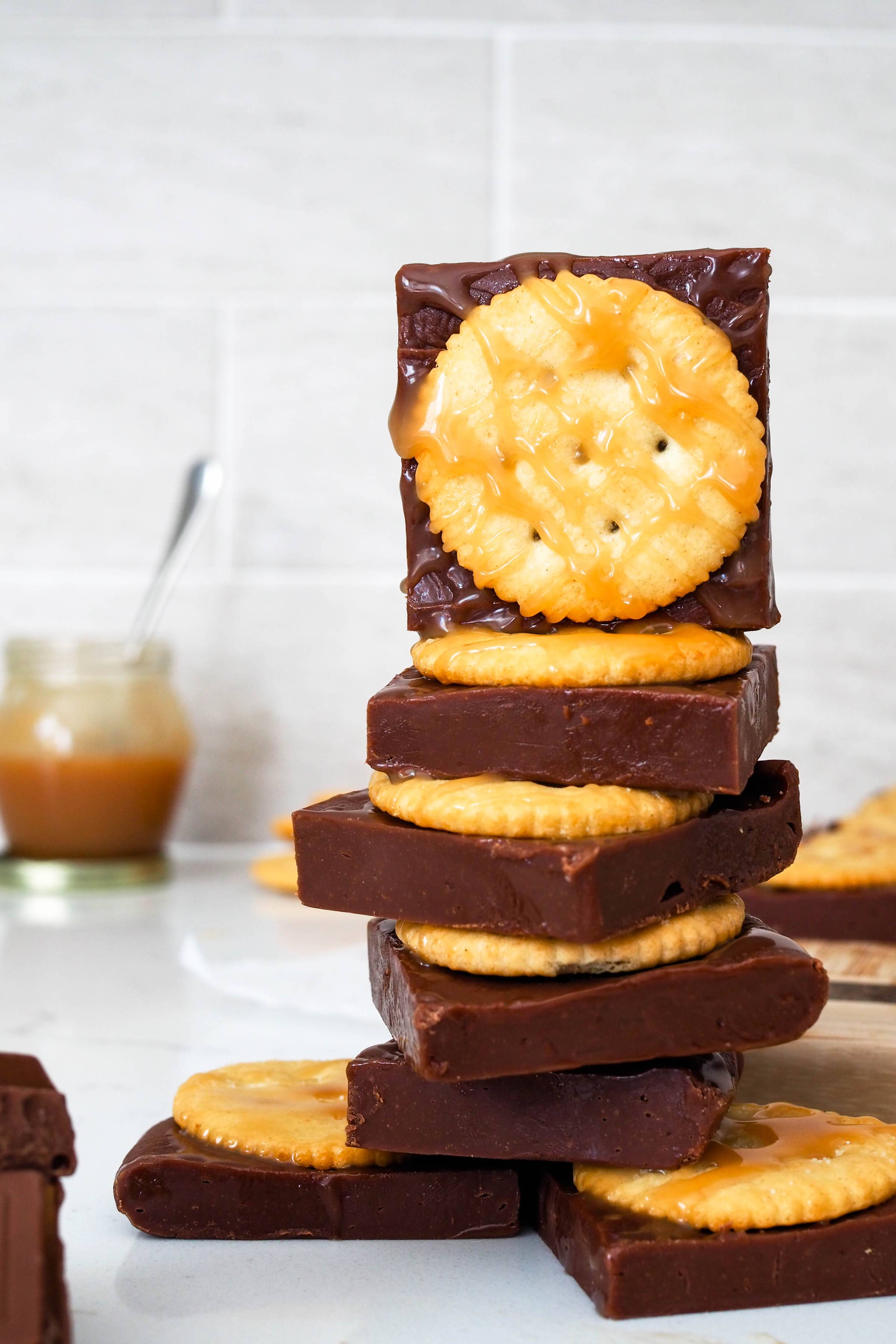 A stack of fudge squares with Ritz crackers and salted caramel.