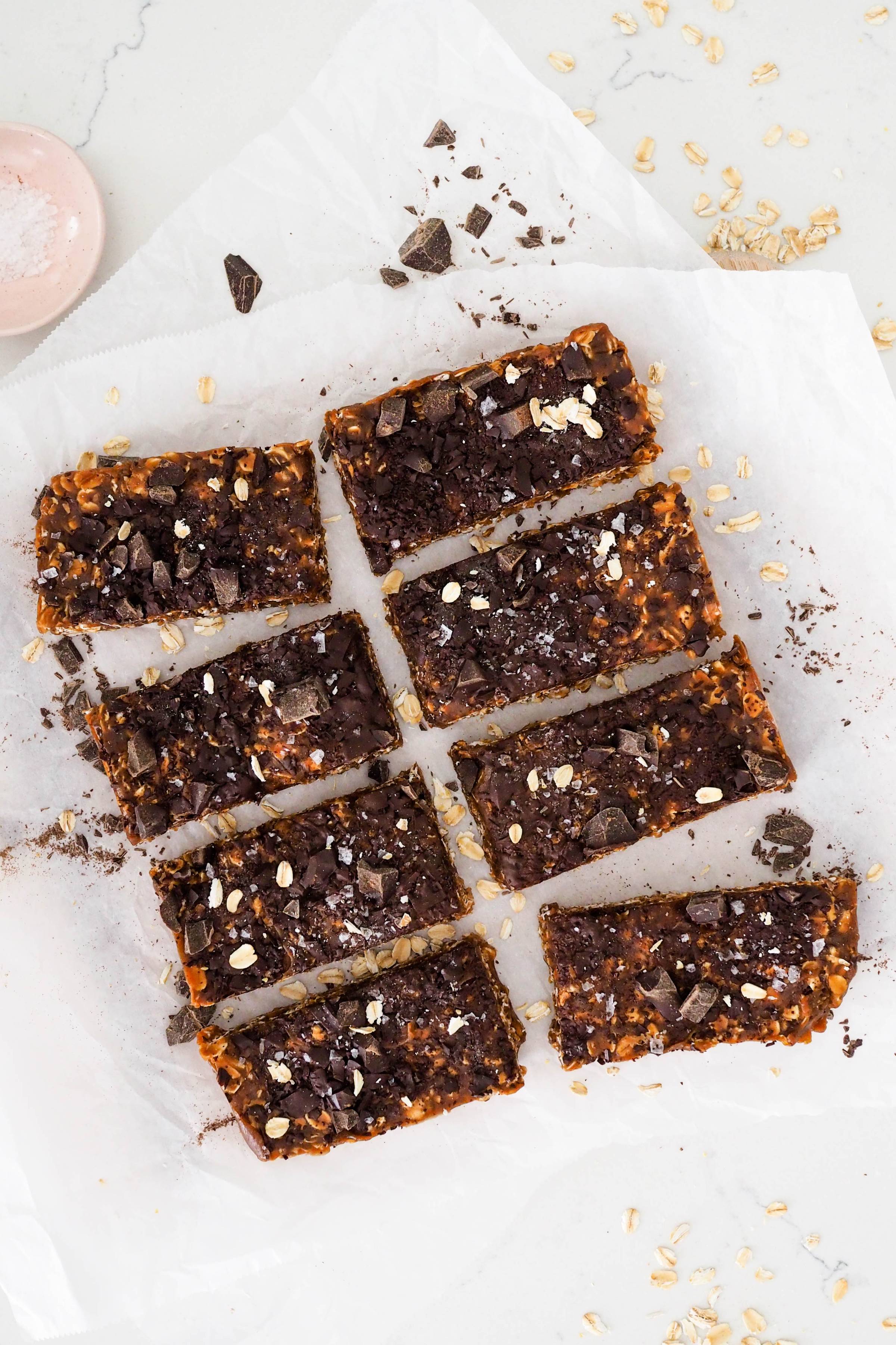 Eight granola bars arranged on parchment paper.