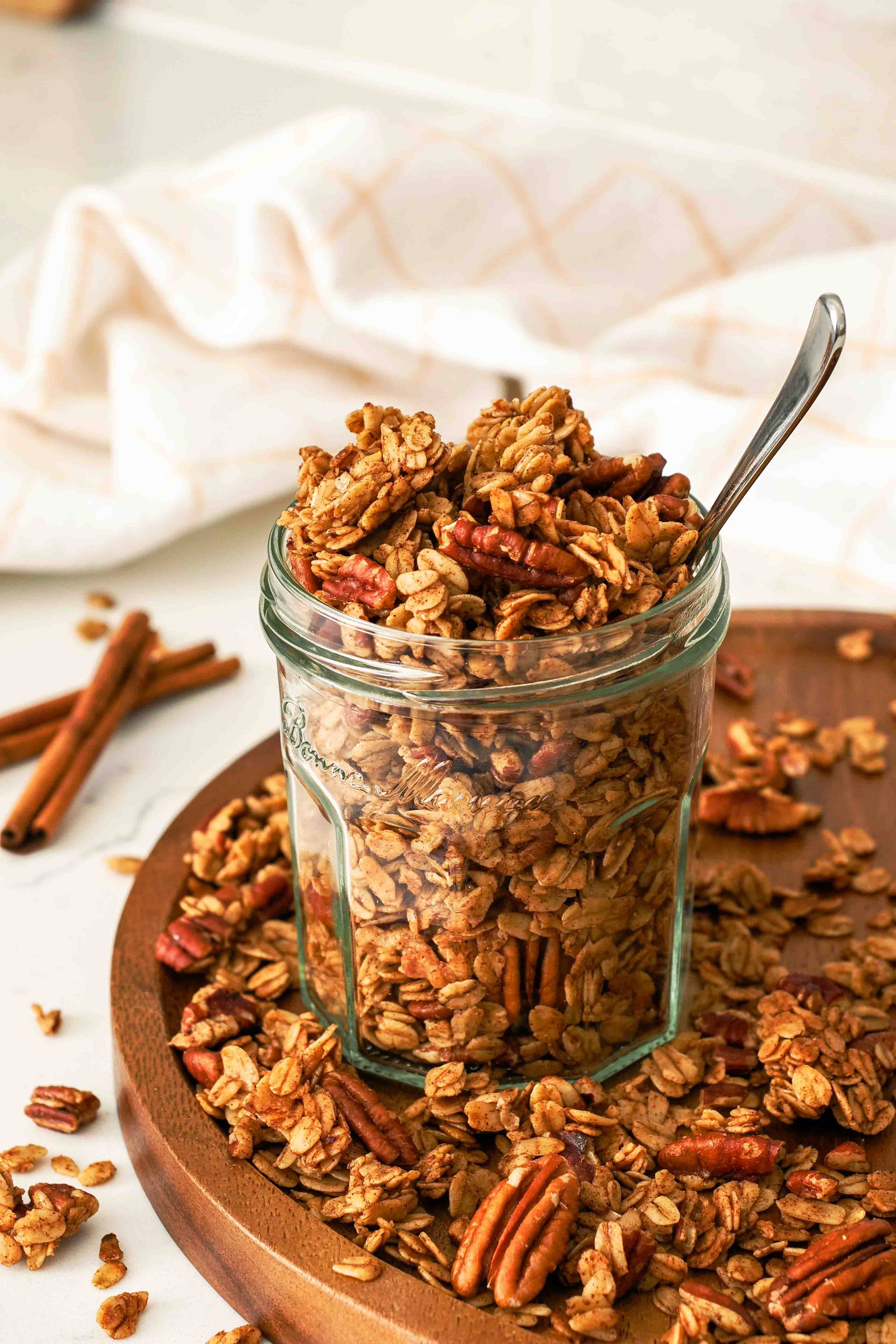 A jar of granola with a spoon.