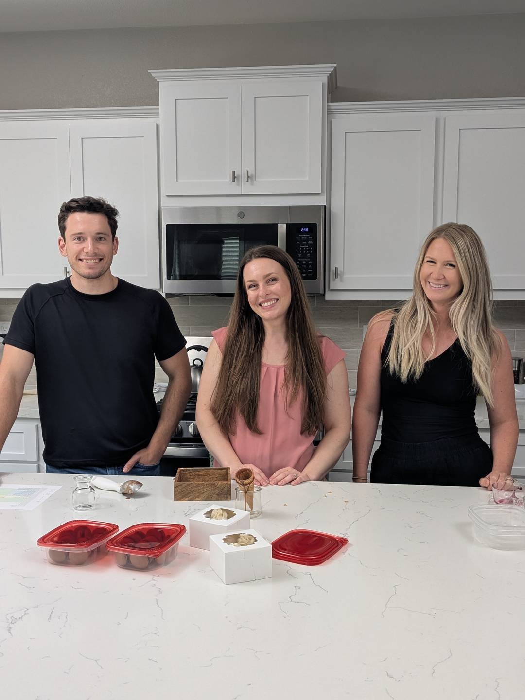 Alyssa in the kitchen with a videographer and photographer
