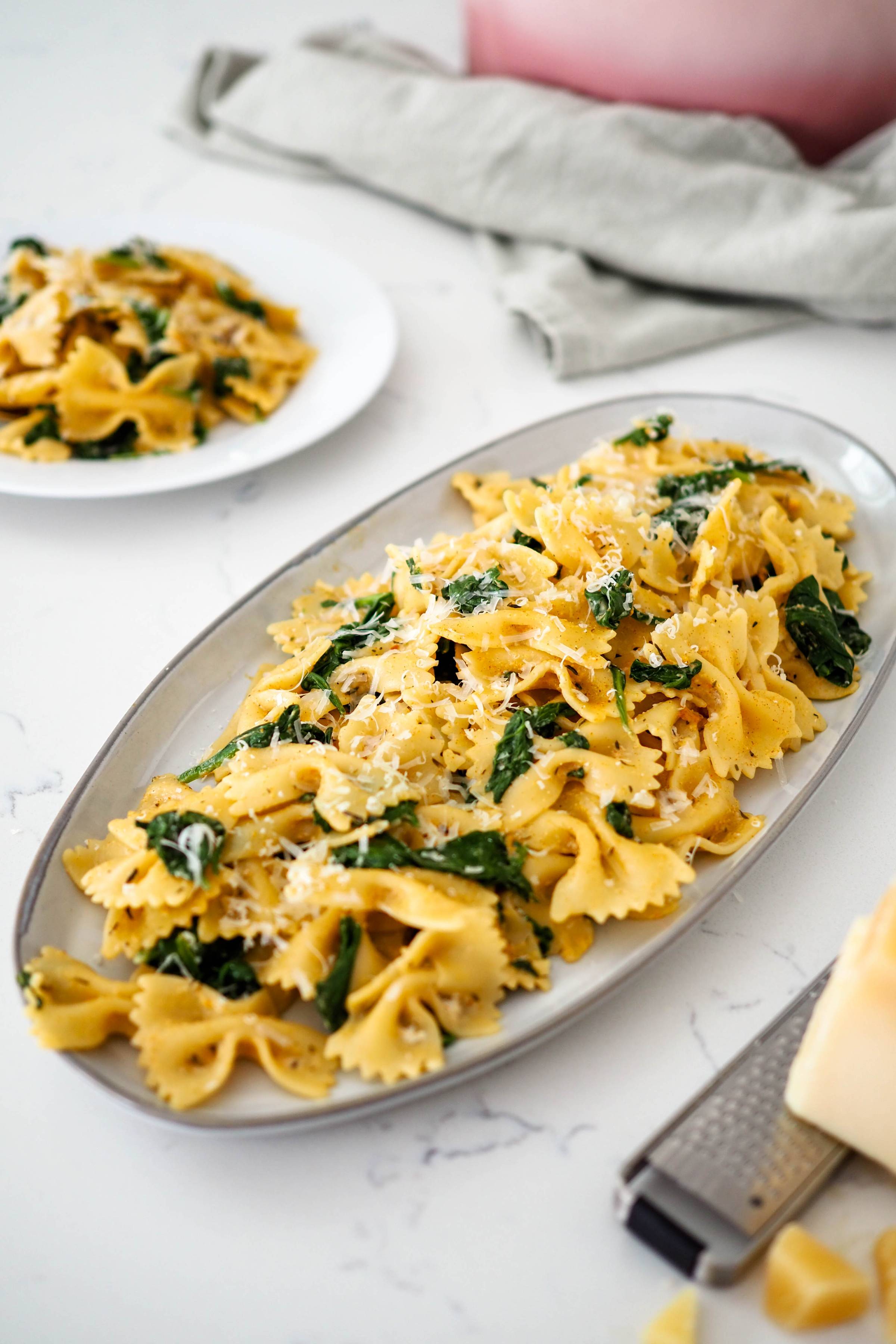 Bowtie pasta with spinach on a platter
