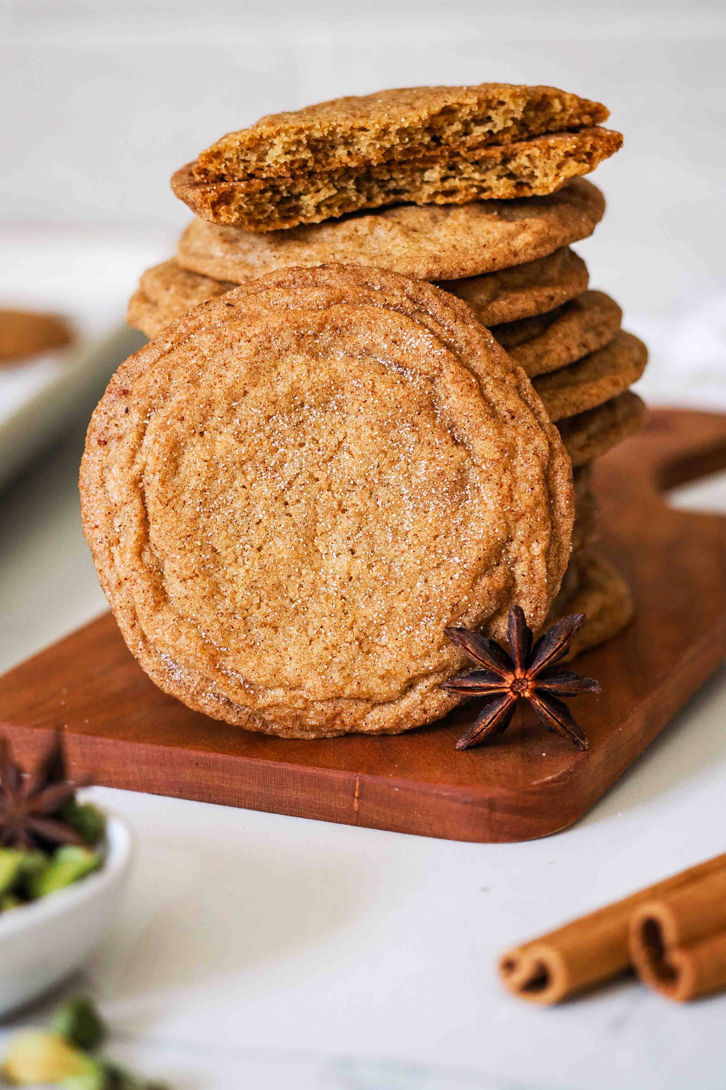 A chai-spiced cookie leans against a stack of cookies.