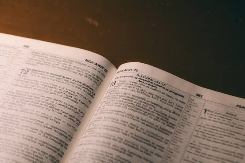 An open book with handwritten texts is shown.