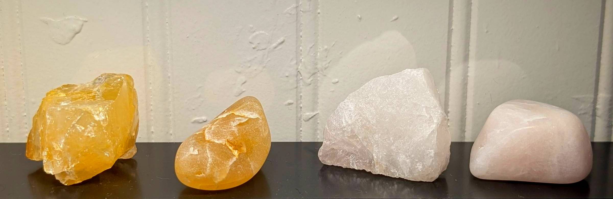 four rocks, two tumbled and smooth and two rough