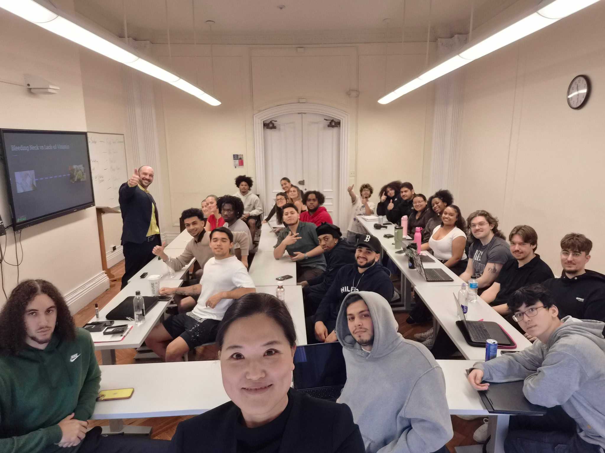 a college classroom of students with Dan Newman at the front of the room