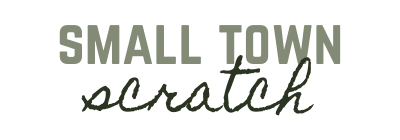 The image contains the text "SMALL TOWN" in bold, block letters above the word "scratch" written in a cursive, script style. All the text is in a shade of green.