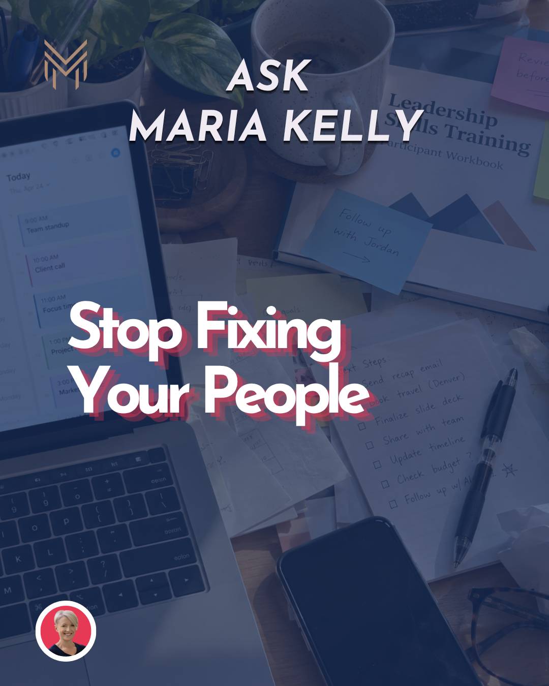 A messy desk with the training manual buried under files