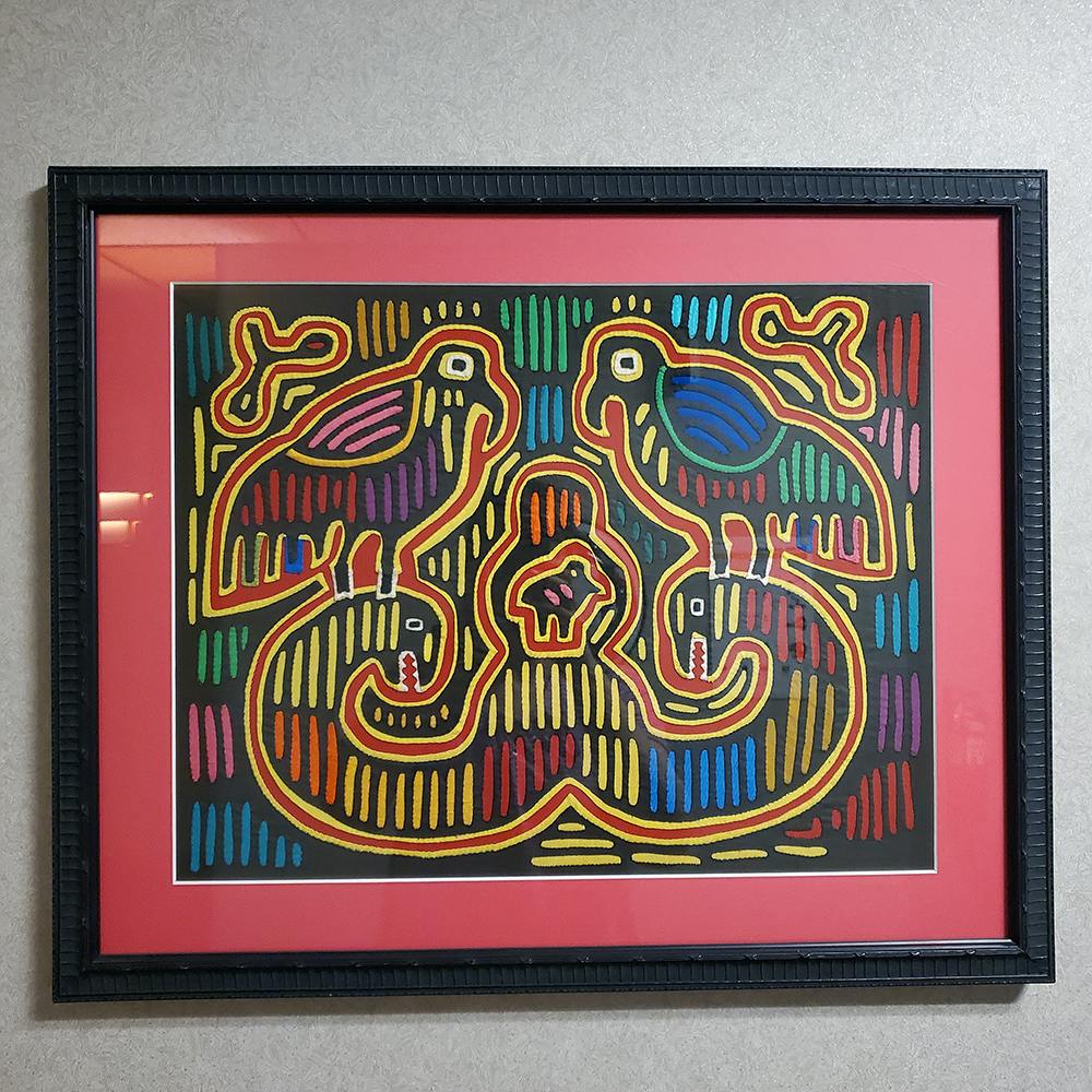 Photo of framed Mola art hanging in an Oklahoma City hospital.