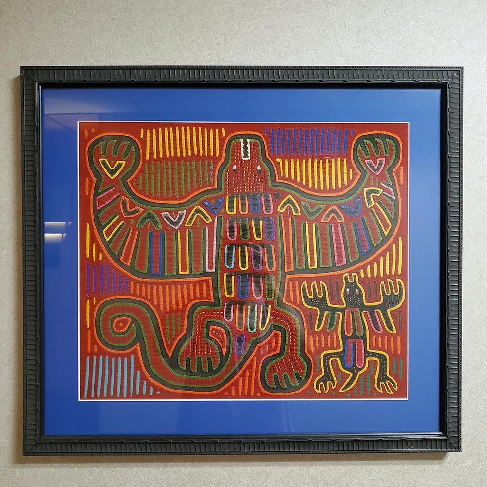 Photo of framed Mola art hanging in an Oklahoma City hospital.