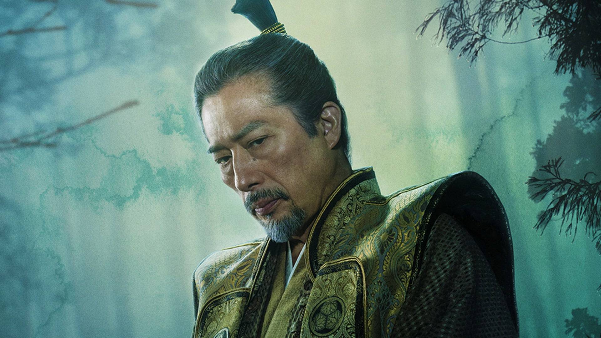  Promotional image for the Hulu show Shogun, 2024, featuring actor Hiroyuki Sanada as Yoshii Toranaga. The Japanese man shown here is looking pensively to his lower left, posed against a painterly teal background. He is dressed in traditional samurai costume from the 17th century. 