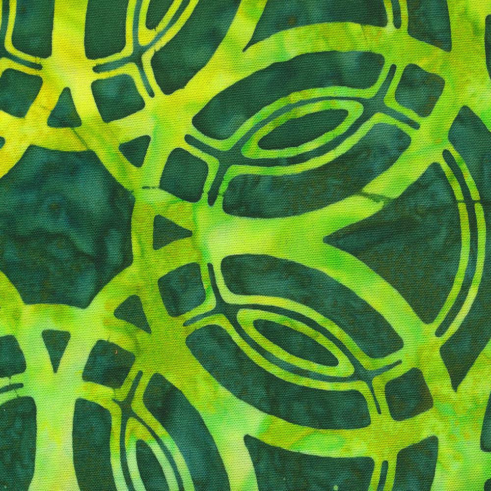 Closeup photo of a piece of cotton fabric, dyed light green, printed with wax resist in a pattern of overlapping circles, then overdyed with dark green.