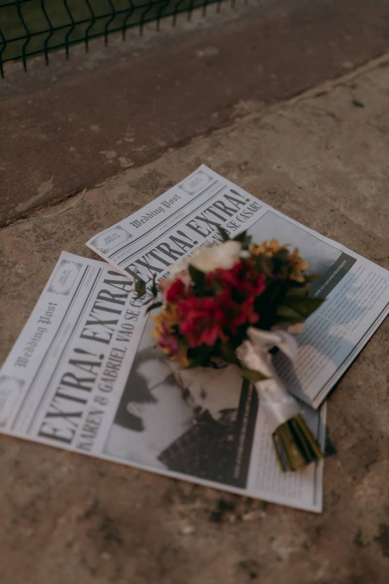 A wedding bouquet rests on newspapers.